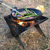 Fire Pit and Cooking Pan with Steak & Asparagus being cooked on flame