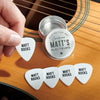 personalised guitar plectrum placed on top of an acoustic guitar